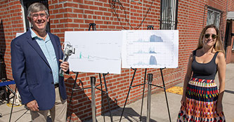Brett Branco stands with a sensor and a data board with Rebecca Fischman.