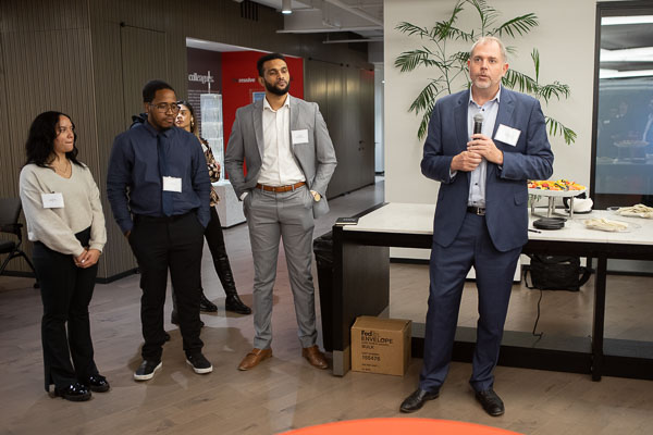 Aaron Olson, Executive Vice President of Aon United Solutions at Aon, speaks at an event at Aon's New York City headquarters celebrating the launch of the Career Partners and Alumni Championship programs at Brooklyn College.