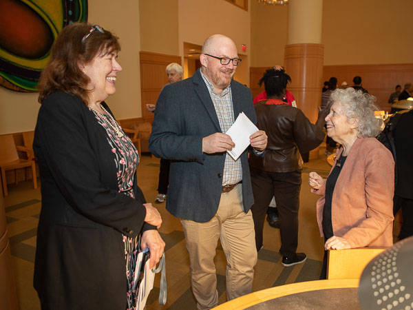 Attendees at the annual book party gather in the library.