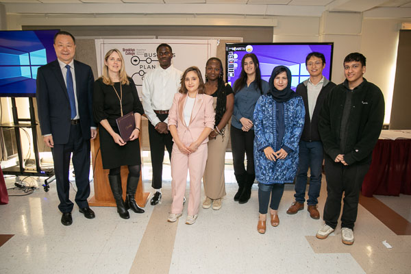 Dean Qing Hu and Professor Veronica Manlow with competitors at the Koppelman Entrepreneurship Competition