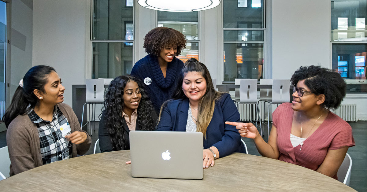 Tarika Barrett ’96, CEO of Girls Who Code, center, with alumnae from the program.
