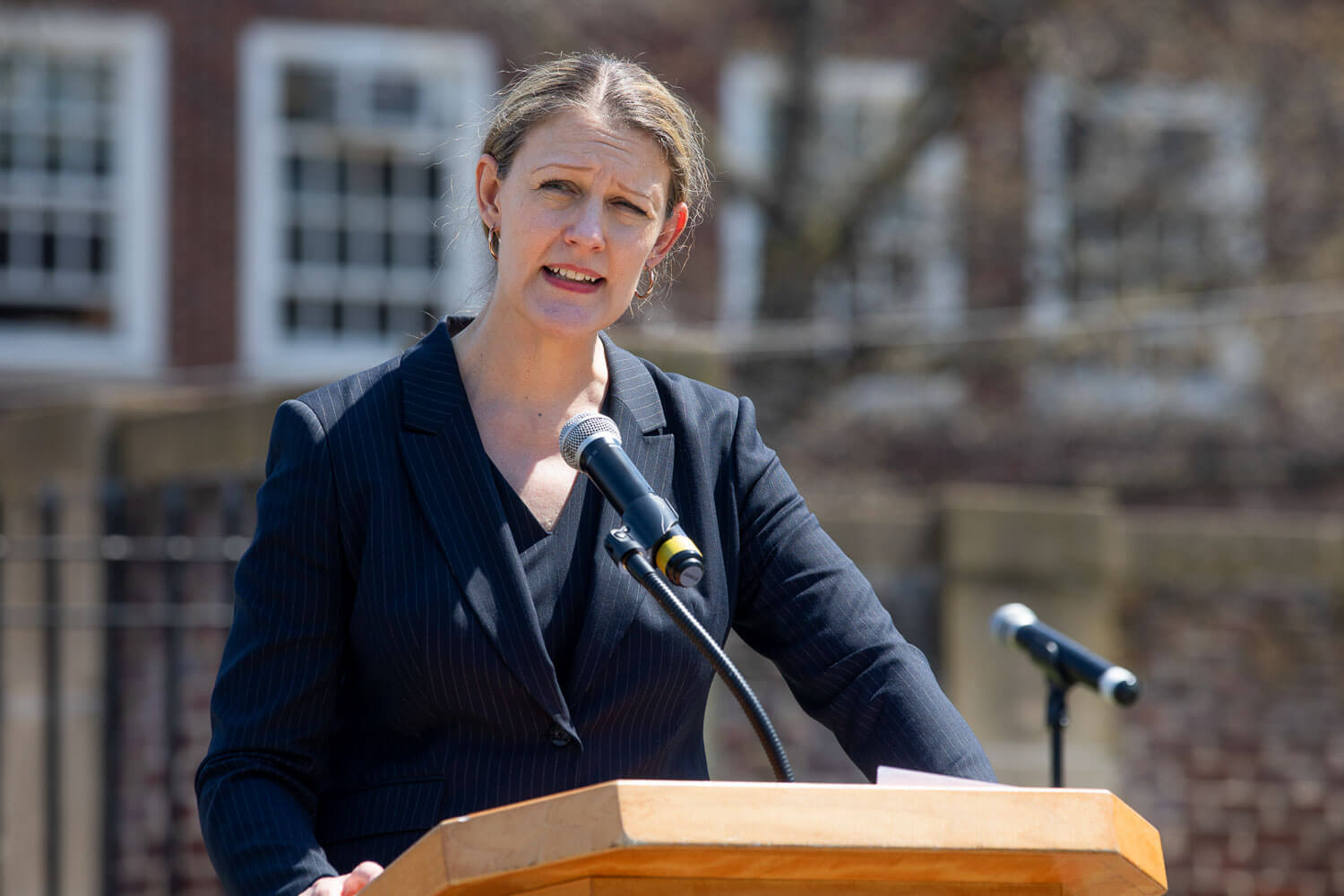 President Michelle J. Anderson speaks at memorial to campus family lost to the pandemic.