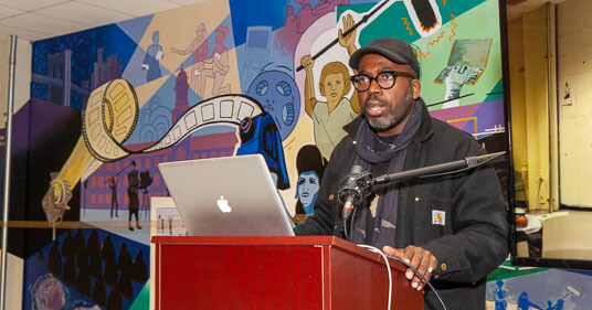 Derrick Adams, an accomplished mural artist and Professor of Art who served as an advisor on the mural project, addresses the audience on December 14.